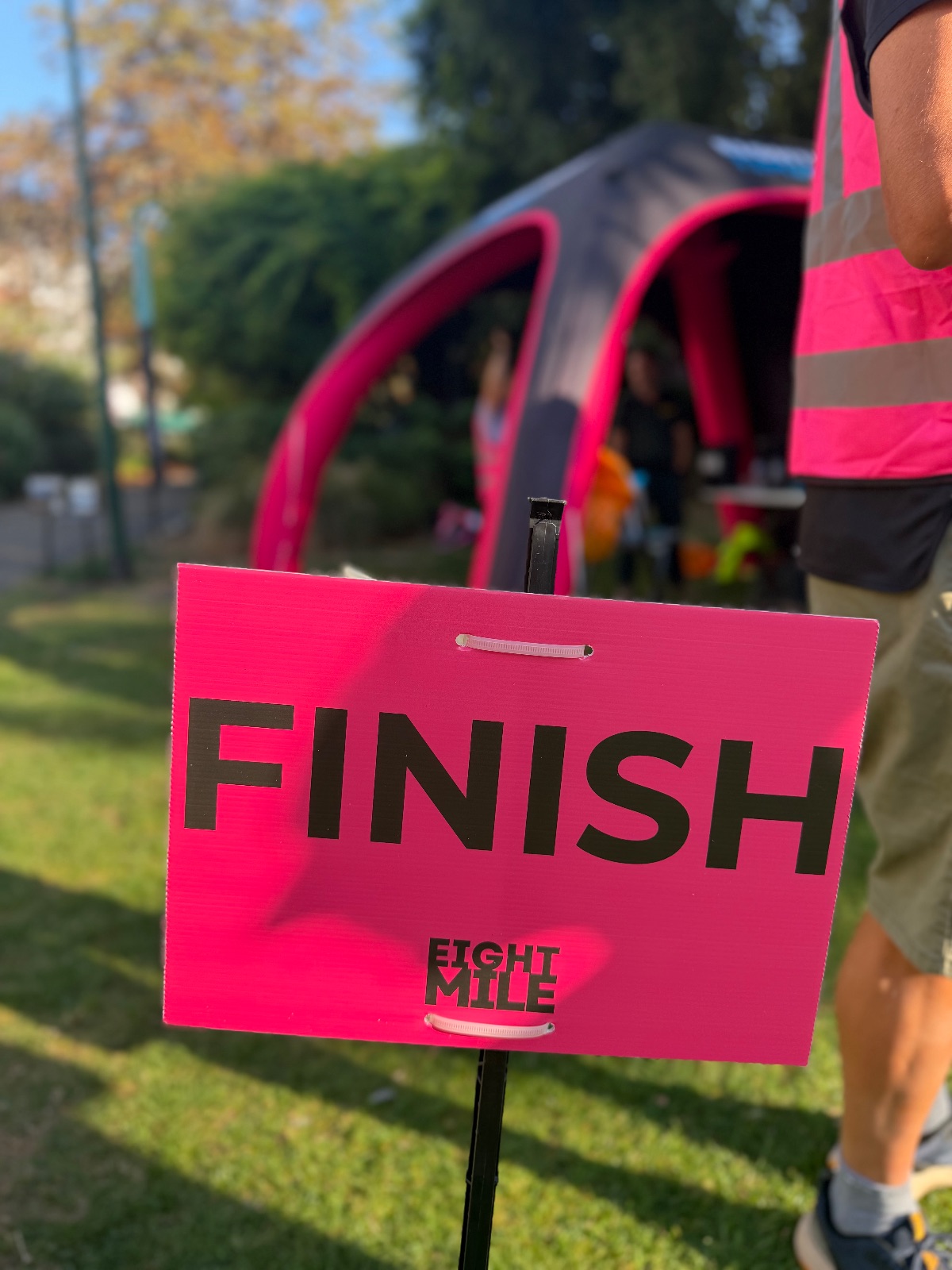 Pink Eightmile finish sign in front of the finish tent