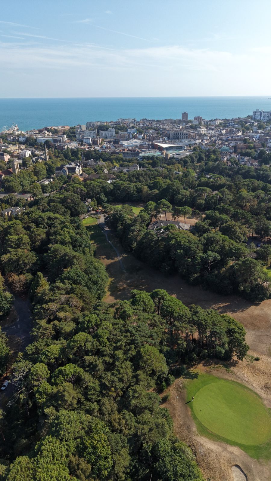 Aerial from Meyrick Park over Bournemouth town to the sea