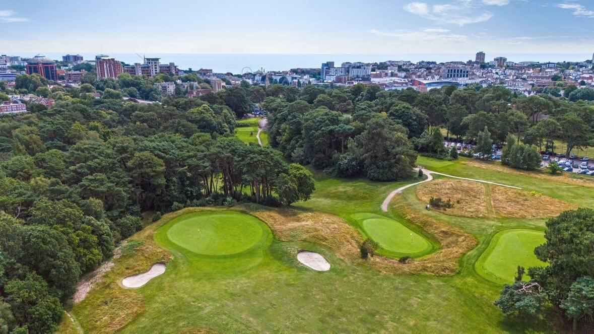 Aerial view of Meyrick Park greens with Bournemouth town and sea beyond