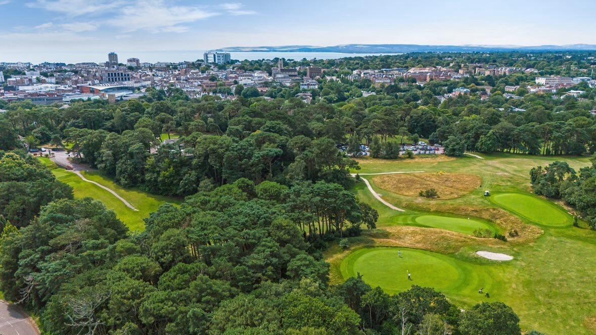 Meyrick Park pines and parkland with Bournemouth town and the sea beyond